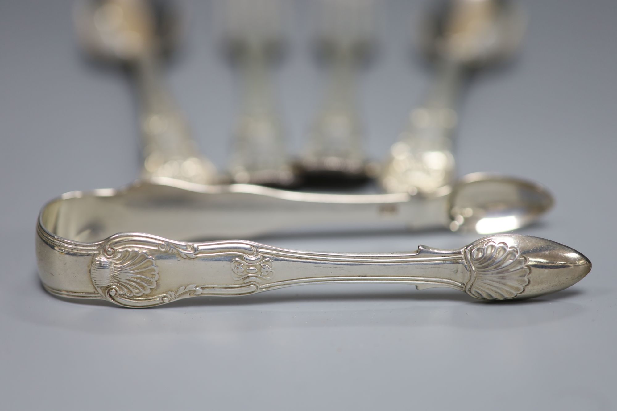 A pair of George IV silver hourglass pattern table forks and pair of dessert spoons and a pair of sugar tongs, 12.7oz
